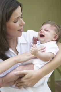 Mother comforting crying baby