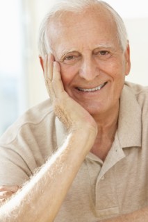 Senior man resting chin in hand