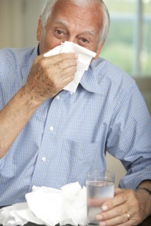 Senior man wiping his nose