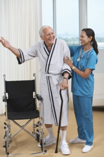 Nurse helping Senior patient use cane