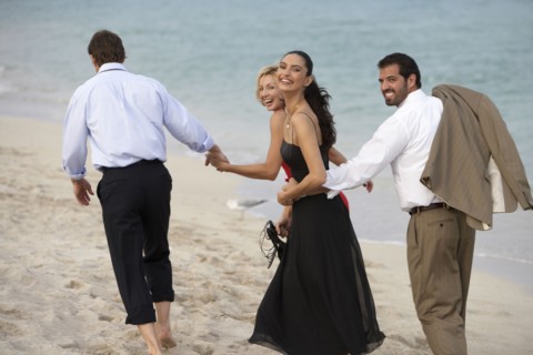Couples walking together on beach