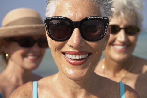 Senior woman wearing sunglasses on beach