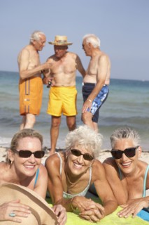 Senior friends relaxing on beach