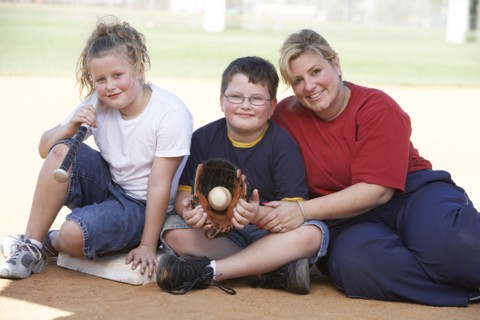 Mother and children smiling outdoors