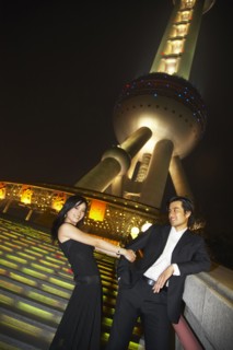 Couple below Oriental Pearl Tower at night