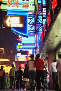 Couple on city street lit up at night