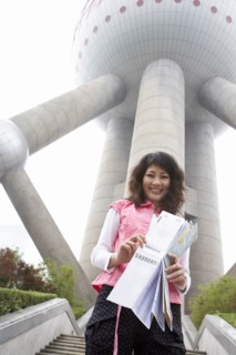 Chinese woman with map under Oriental Pearl Tower
