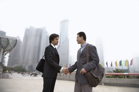 Chinese businessmen shaking hands
