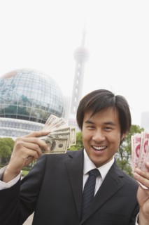Chinese businessman holding wads of money