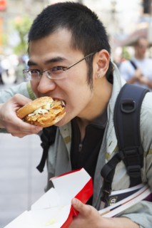 Chinese man eating on city street