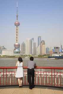 Chinese couple looking at city skyline