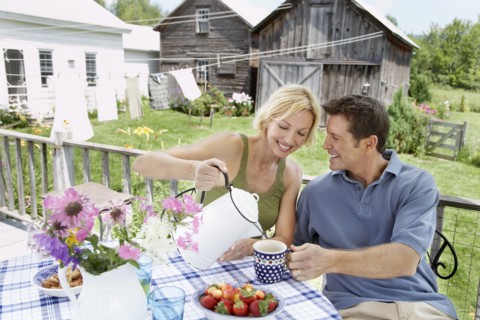 Couple having coffee on patio