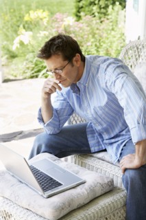 Man using laptop on patio