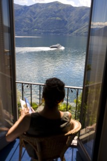 Woman overlooking rural lake from balcony