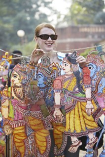 Caucasian woman admiring traditional art in outdoor market