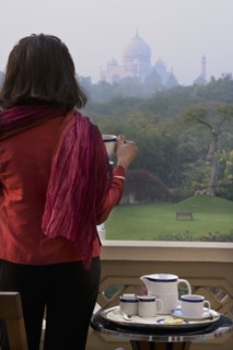 Caucasian woman overlooking Taj Mahal from balcony