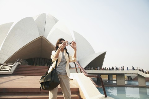 Caucasian tourist taking pictures at Bahai Temple