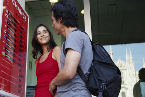 Couple checking currency exchange rates