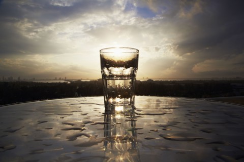 Empty glass on wet table outdoors