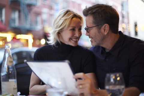 Caucasian couple eating at urban cafe