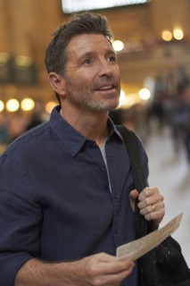 Caucasian man reading train schedule in Grand Central Station