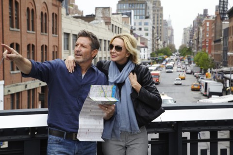 Caucasian couple holding map in city