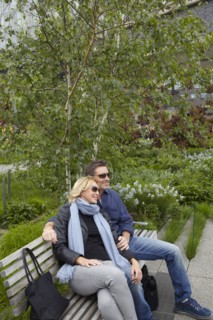 Caucasian couple relaxing on bench in park