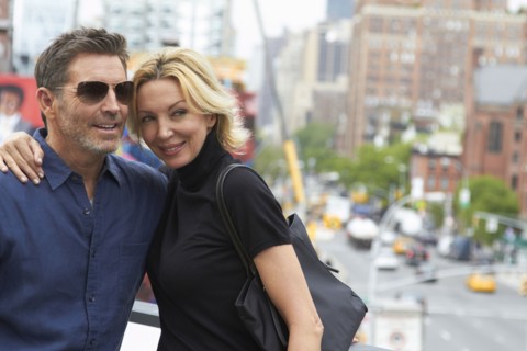 Caucasian couple hugging in city