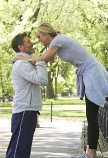Caucasian couple playing in park