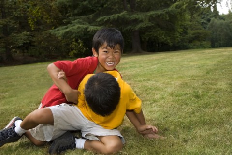 Asian boys playing in park