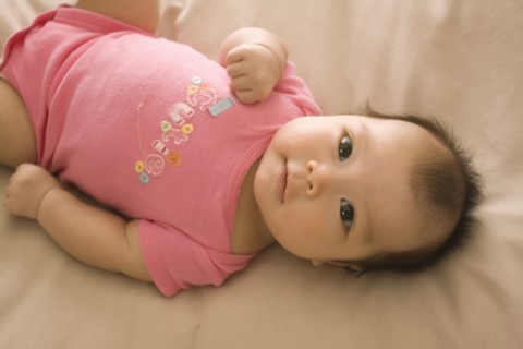 Chinese baby girl laying on bed