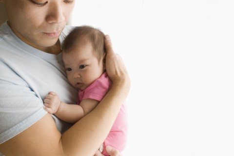 Chinese father holding baby daughter