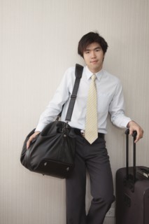 Chinese businessman standing with luggage
