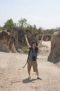 Chinese tourist laughing with arms raised