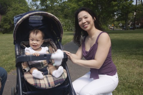 Chinese mother and baby in stroller at park