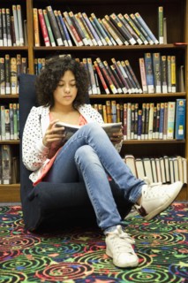 Mixed race girl studying in library