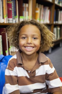 Boy smiling in library