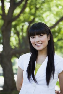 Asian woman smiling in park
