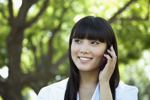 Asian woman talking on cell phone
