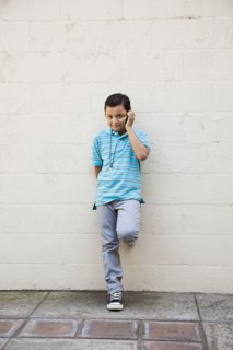 Mixed race boy talking on cell phone