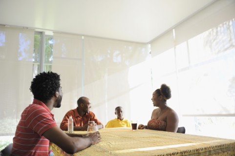 Black family sitting at dining room table