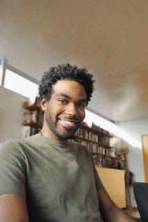 Black man smiling in living room