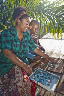 African American woman solving puzzle with family on patio