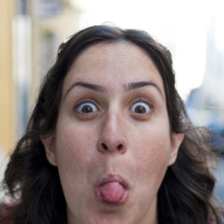 Caucasian woman sticking out tongue