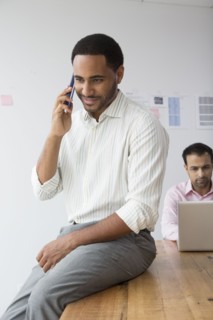 Businessman talking on telephone in office