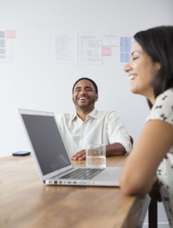 Business people laughing in meeting