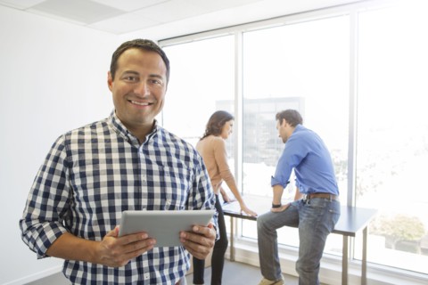 Businessman using digital tablet in office