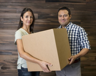Business people carrying cardboard box in office