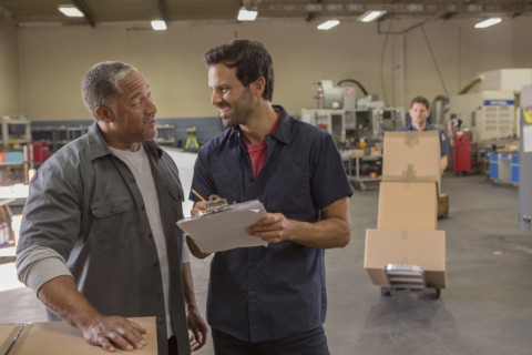 Workers talking in warehouse