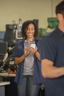 Worker using cell phone in warehouse